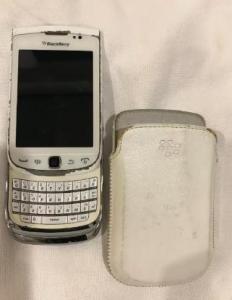 White flipped BlackBerry Torch 9810 with original leather case